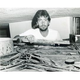 Jeff Quinn above the roof of his kitchen pantry eaten away by termites, Lansvale, NSW
