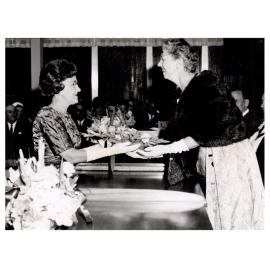 Mayoress of Fairfield presenting flowers to Lady Woodward, Fairfield, NSW