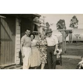 Two couples standing in front of a Nissen Hut, Cabramatta Migrant Hostel, Cabramatta NSW