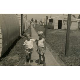 Two boys standing on a path at the Cabramatta Hostel, Cabramatta NSW