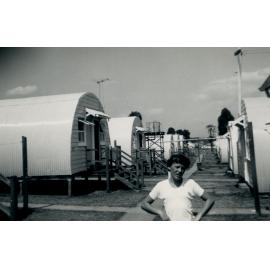 A young boy standing in front of the Nissen Huts, Cabramatta Migrant Hostel, Cabramatta NSW