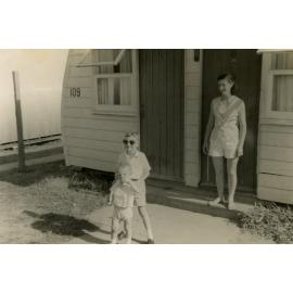 A woman and two children outside a Nissen Hut, Cabramatta Migrant Hostel, Cabramatta NSW