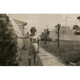 Peggy Pearson standing outside a Nissan Hut, Cabramatta Hostel, Cabramatta, NSW.