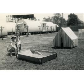 Peggy and Ronald Pearson filling the pool,1960’s, Cabramatta Migrant Hostel, Cabramatta, NSW.