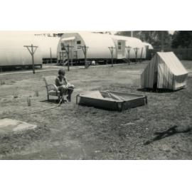 Young boy filling a pool, Cabramatta Hostel, Cabramatta, NSW.
