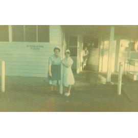 Four women standing on the Kitchen No.1 porch, Cabramatta Migrant Hostel, Cabramatta NSW, late 1960s