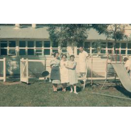 Group of people at the side of the kindergarten, Cabramatta Migrant Hostel, Cabramatta NSW, late 1960s
