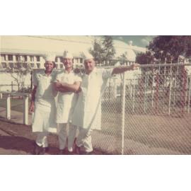 Three men leaning on a fence, Cabramatta Migrant Hostel, Cabramatta, NSW.