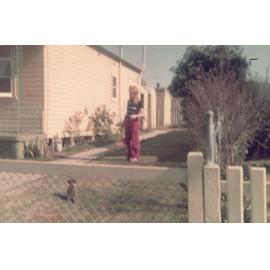 A woman in a backyard.