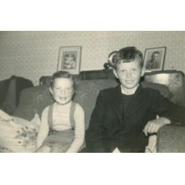Two children sitting on a lounge